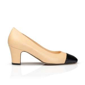 Introducing the Piazza Grande Pump, the epitome of sophistication and style. This nude heel pump features a touch of black for a sleek and polished look. With its timeless design and expert craftsmanship, elevate your wardrobe with this luxurious and versatile shoe. front view
