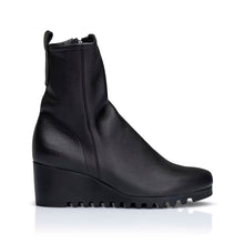 Embrace the comfort of the wedge with this mid-calf style boot available in calf skin leather or nubuck. Featuring a fashionable crepe sole for extra-grip and style on wet city streets. Inside side zip,  pull-on tab, top stitch feature with a rounded toe. black