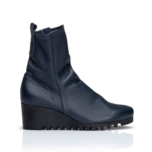 Embrace the comfort of the wedge with this mid-calf style boot available in calf skin leather or nubuck. Featuring a fashionable crepe sole for extra-grip and style on wet city streets. Inside side zip,  pull-on tab, top stitch feature with a rounded toe. side view